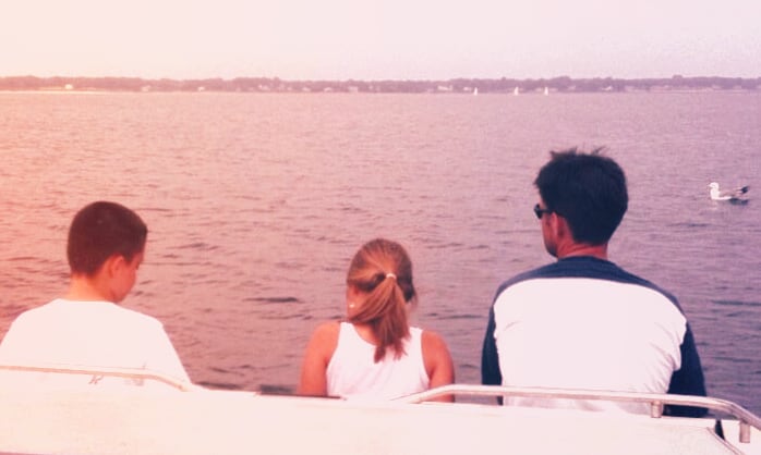 The BC Marine Canvas family sitting together on a boat